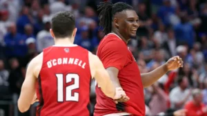 Players celebrating a victory as the lowest seeds in March Madness.