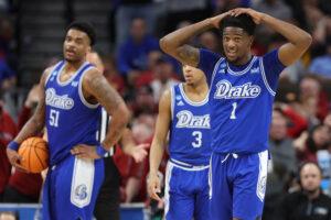 Players celebrating men’s college basketball upsets